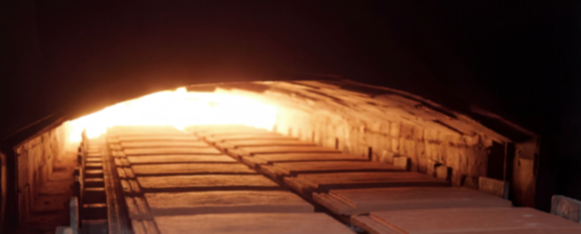 Tiles entering the kiln tunnel toward the flames